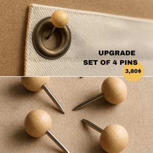 May include: A set of four push pins featuring smooth, round, light-colored wooden heads and sharp metal points. One pin is shown inserted through a brass-colored metal grommet on a piece of off-white fabric, while three others are displayed separately.