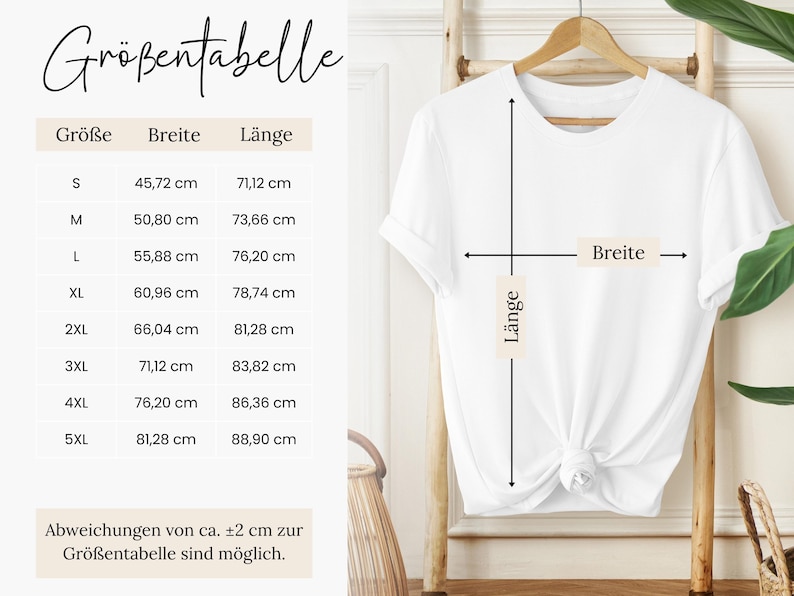 a white t-shirt hanging on a wooden hanger, with measurements and a description of the t-shirt's size and style.