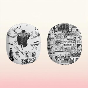May include: Two round, white, wireless earbud cases with black and white manga-style illustrations. One case features a character from the anime One Piece, the other case features a collage of manga panels.