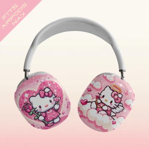 May include: Pink AirPods Max headphones with a white headband. The earcups feature a Hello Kitty design with hearts, roses, and angel wings. Text on the upper left says "FITS AIRPODS MAX".