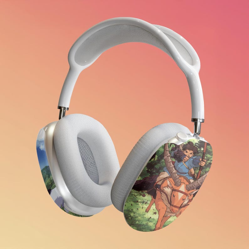 May include: White wireless headphones with a colorful anime graphic on the right earcup. The graphic features a character riding a deer-like creature through a forest.