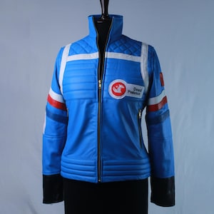 May include: A bright blue jacket with a high collar and a front zipper. It features white and red horizontal stripes on the sleeves, quilted shoulder panels, and black cuffs. A circular patch on the chest displays a red horse logo and the text Dead Pegasus.