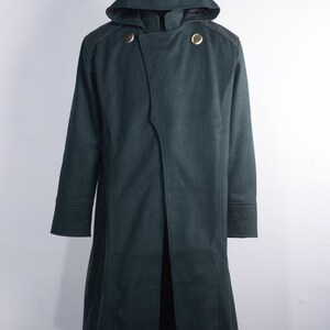 May include: A dark green hooded coat with a double-breasted design. The coat features two gold-colored buttons, shoulder accents, and a long, flowing silhouette. The sleeves have detailed cuffs.