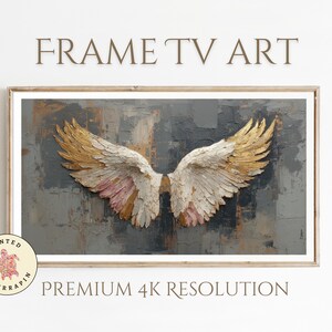 May include: Framed artwork featuring a pair of textured angel wings with gold, white, and pink hues against a gray and brown background. The words "FRAME TV ART" and "PREMIUM 4K RESOLUTION" are displayed above and below the artwork.