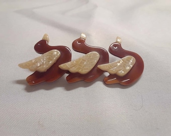 Lea Stein Laminated Plastic Ducks in a Row Brooch Red Brown w/ Iridescent Cream Wings