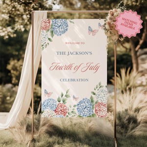 May include: A Fourth of July celebration sign with the text "Welcome to The Jackson's Fourth of July Celebration." The sign features watercolor hydrangeas in red, white, and blue, with butterfly accents. A pink tag reads "Matching Items Available."