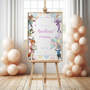 May include: A wooden easel displays a birthday sign with the text "Welcome to Amelia's 5th birthday" and cartoon characters. The sign is decorated with balloons and stars, and surrounded by peach-colored balloons.