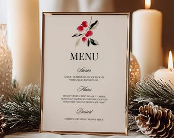 May include: A rectangular menu card in a thin gold frame featuring a watercolor illustration of red berries and green leaves at the top. The text reads MENU, Starter, Garlic mushrooms on sourdough with garlic rapeseed oil, Mains, Roast turkey, crispy roast potatoes, seasonal vegetables, parsnips, sage and onion stuffing and homemade gravy, Dessert, Christmas pudding, brandy sauce.