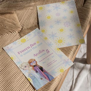 May include: Two rectangular birthday invitation cards featuring a pattern of yellow suns and light blue snowflakes. One card displays the text Frozen fun under the sun, Amelia is turning 5, May 27, 3pm, 168 Sunny Lane, Islington, London.