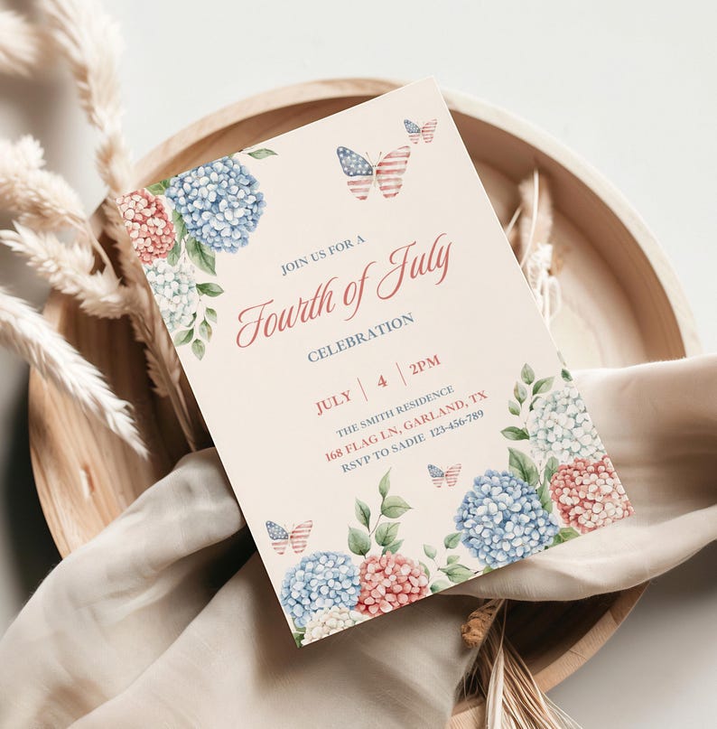 May include: A Fourth of July celebration invitation card with floral and butterfly accents. The card features blue, red, and white hydrangeas and butterflies with an American flag design. The text reads "Join us for a Fourth of July Celebration."