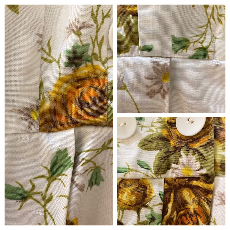 May include: Close-up of a white fabric with a floral pattern featuring yellow roses, green leaves, and white daisies. The fabric has a textured surface and is pleated.