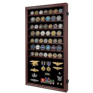 May include: A dark wood display case with multiple shelves, filled with military challenge coins and insignia. The case has a glass front and is designed to showcase a collection of military memorabilia. The coins are round with various designs and colors.