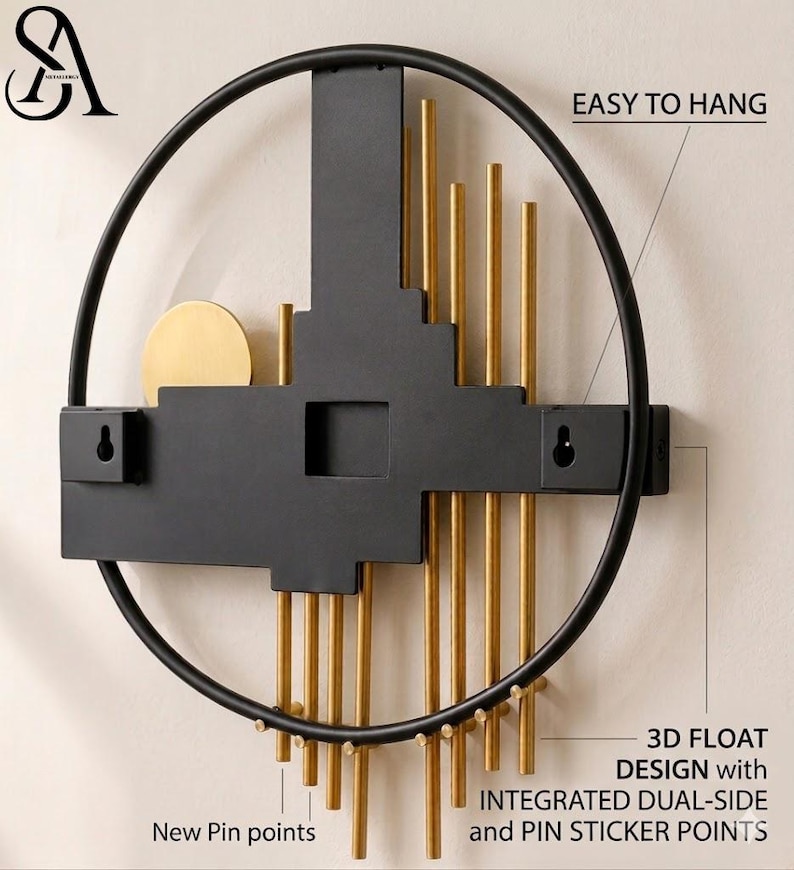 May include: A circular wall art piece featuring a black metal frame and a central black geometric structure. It includes vertical gold rods, a gold circular accent, and two keyhole mounts labeled EASY TO HANG, 3D FLOAT DESIGN, and New Pin points.