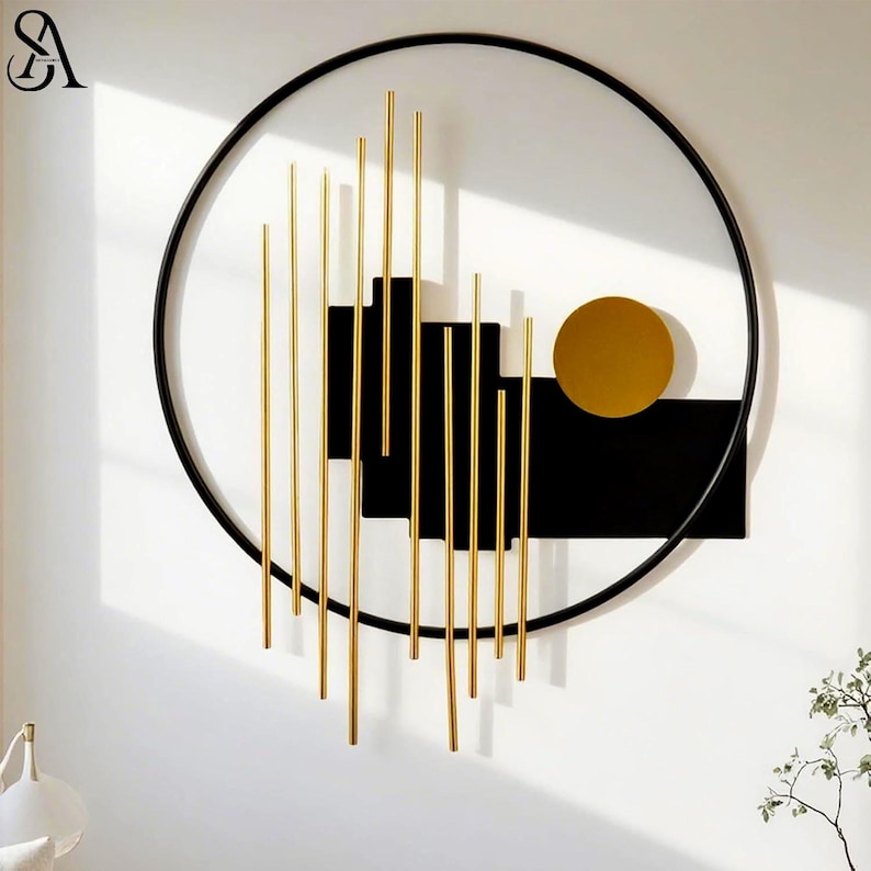 May include: A circular wall art piece featuring a thin black metal frame. Inside, vertical gold metal rods of varying lengths are arranged in front of a solid black rectangular panel. A single solid gold circle is positioned to the right side.