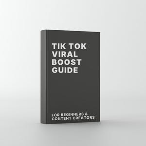 Puede incluir: Un libro gris oscuro con el título "TIK TOK VIRAL BOOST GUIDE" en texto blanco. El subtítulo dice "FOR BEGINNERS & CONTENT CREATORS". El libro está de pie sobre un fondo blanco.