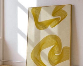 May include: Abstract art print featuring two flowing, ribbon-like shapes in a golden yellow hue against a cream background. The artwork is framed in a thin, gold-colored frame, leaning against a white wall. The piece evokes a sense of movement and fluidity.