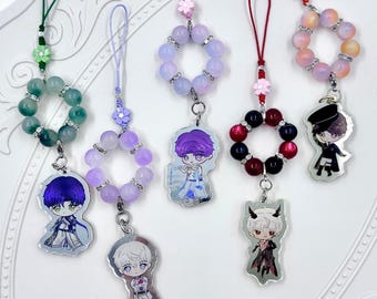 May include: Six colorful phone charms featuring anime-style characters. Each charm has a silver metal ring with a beaded chain and a small character charm. The beads are in shades of green, purple, pink, and red.