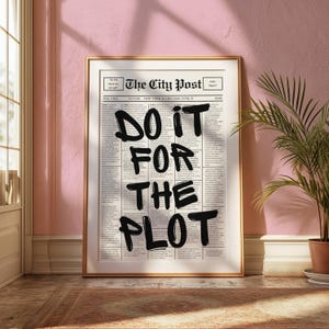 以下が含まれることがあります： 「The City Post」というテキストと、「DO IT FOR THE PLOT」というフレーズが黒のマーカーで書かれた新聞の額装されたプリントです。