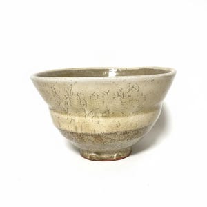 May include: A set of three ceramic mugs with a speckled, matte finish. The mugs are in shades of cream, light gray, and dark gray. Each mug has a simple, minimalist design, perfect for coffee or tea.