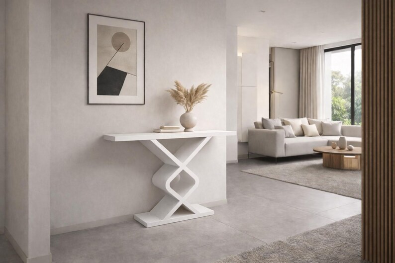 May include: A white console table featuring a flat rectangular top and a geometric base composed of two interlocking, rounded square shapes that connect to a solid rectangular floor plate, providing a stable and balanced structure.