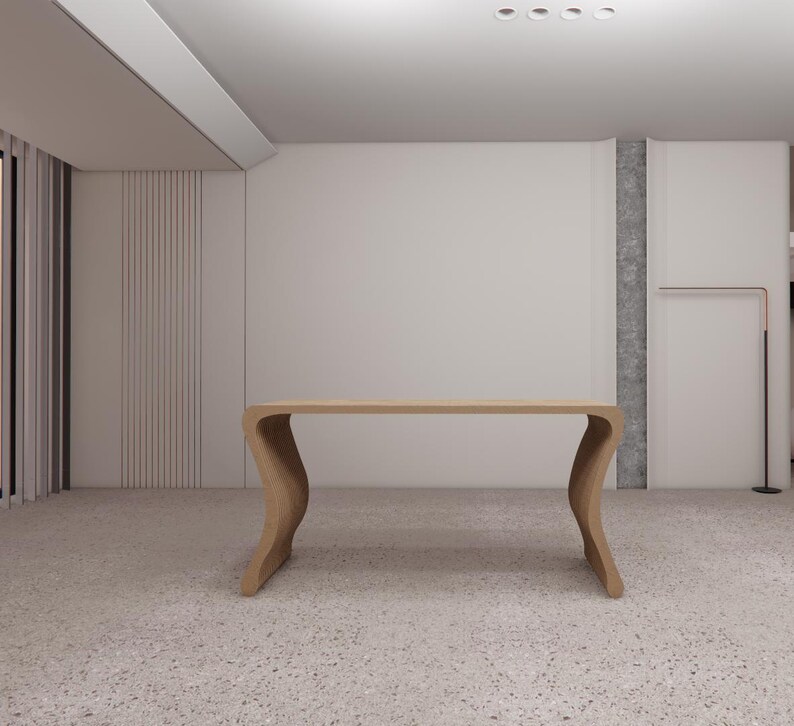 May include: A light-colored wooden desk with a unique, curved leg design. The desk has a long, rectangular top and is set against a neutral-toned wall. The room has a terrazzo floor.