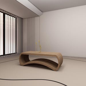 May include: A modern, wooden coffee table with a unique, curved design. The table is light brown and has a lower shelf. The room features large windows with vertical blinds, a neutral color palette, and decorative accents.
