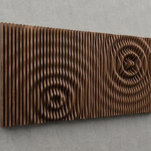 May include: A rectangular wooden wall art piece with a brown finish. The design features vertical lines and two spiral patterns carved into the wood, creating a textured, three-dimensional effect. The artwork is mounted on a grey wall.