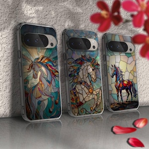 May include: Three clear phone cases with stained glass horse designs. Each case features a different horse illustration in vibrant colors, including blue, red, yellow, and green. The cases are displayed on a reflective surface.