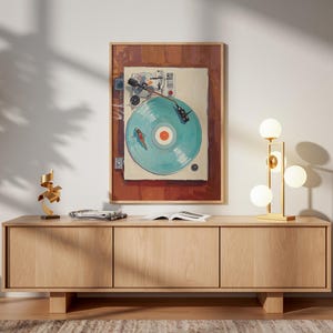 May include: A framed artwork depicts a vintage record player with a teal record. The artwork hangs above a light wood cabinet. A gold lamp with spherical bulbs and a modern sculpture are on the cabinet.