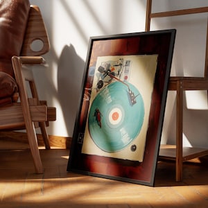 May include: A framed artwork featuring a vintage-style illustration of a record player with a teal record. The artwork is in a dark wooden frame, leaning against a wall. The scene includes a wooden chair and a wooden shelf.