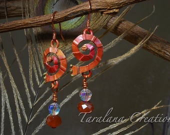 May include: A pair of earrings with a spiral design in shades of red and orange. The earrings are made of metal and have crystal accents.