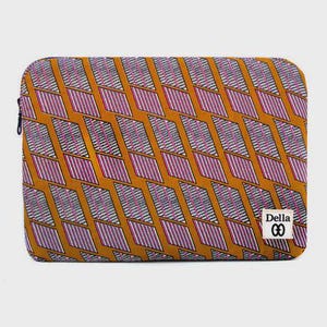 May include: A rectangular laptop sleeve with a repeating geometric pattern in shades of orange, purple, and gray. The design features diagonal lines within diamond shapes. A black zipper runs along the side. The label "Della" is visible.