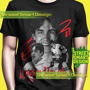 May include: Black t-shirt featuring a collage of a young man in a hockey uniform, with the name "Logan H" in red script. The shirt includes the text "Street Smart Design" in green and yellow.