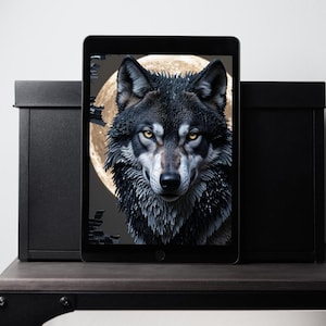 May include: A digital art print of a wolf with piercing yellow eyes, set against a full moon backdrop. The wolf's fur is a mix of black and gray, creating a striking contrast. The artwork is displayed on a tablet, framed by two black storage boxes.