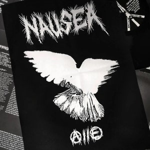 May include: Black and white patch with the word "NAUSEA" in a stylized font, a white dove with its wings spread, and the symbol "@||@" below the dove.