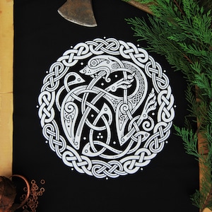 May include: A black fabric patch with a white Celtic knot design featuring a stylized wolf. The wolf is depicted in a circular frame with intricate knotwork.