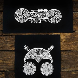 May include: Two black fabric patches with white Celtic knot designs. The top patch features a symmetrical design with two circles and a central knot. The bottom patch features a crescent moon shape with two circles and two arrows.