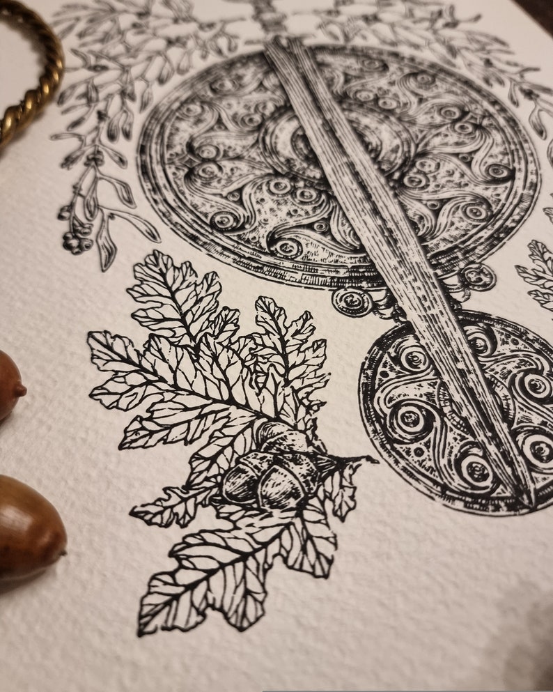 May include: Black and white ink drawing of a sword and shield with intricate Celtic knotwork designs. The sword is positioned vertically, with the shield behind it. A branch with leaves and acorns is in the foreground.
