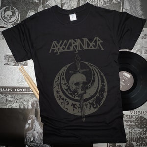 May include: Black t-shirt with a gray skull and sword graphic. The text "AXGRINDER" is printed above the graphic.