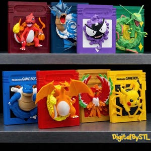May include: A display of vibrant 3D-printed Nintendo Game Boy cartridge replicas, each showcasing a different Pokémon character. The cartridges are in various colours, including red, blue, purple, green, and yellow, with "Nintendo GAME BOY" text.