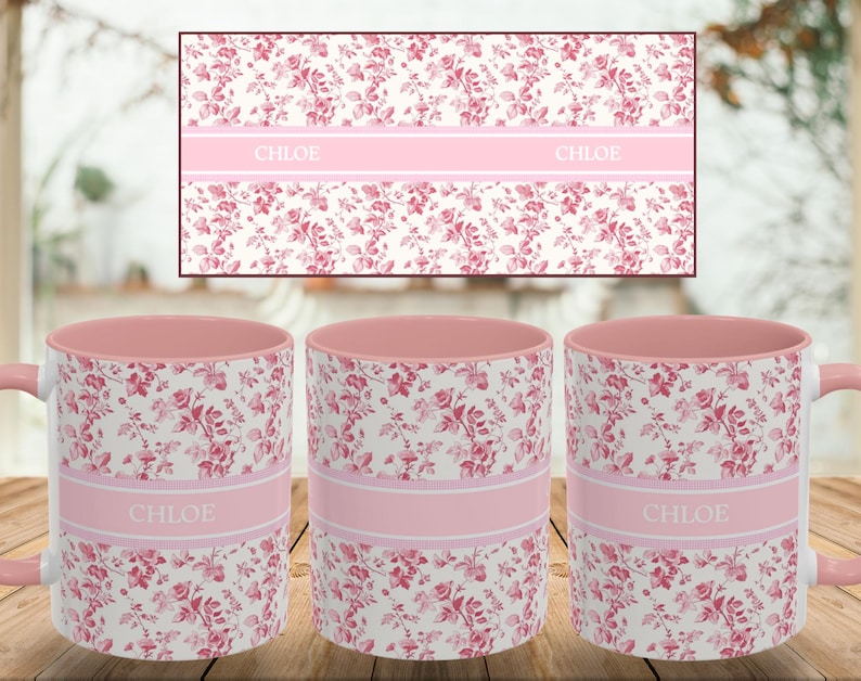 May include: Three ceramic mugs with a floral pattern in pink and white. Each mug has a pink interior and handle. A pink band with the name "CHLOE" is printed on each mug. A matching floral design is in the background.