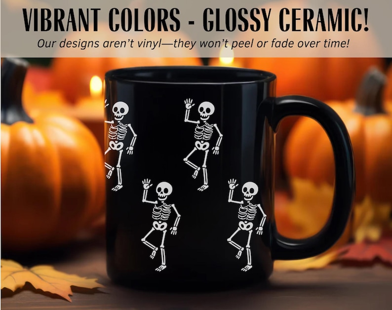 May include: Black ceramic mug with white skeleton illustrations. The mug has a large handle and features the text "VIBRANT COLORS - GLOSSY CERAMIC!" and "Our designs aren't vinyl-they won't peel or fade over time!" in white.