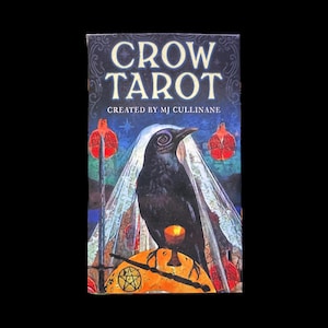 May include: A tarot card deck titled "Crow Tarot" with a black crow illustration. The card features the text "CROW TAROT" and "CREATED BY MJ CULLINANE". The crow is perched on a golden surface with a pentagram.