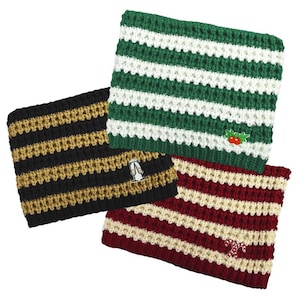 May include: Three knitted striped scarves with different colored stripes and embroidered designs. The first scarf is green and white with a holly design. The second scarf is black and gold with a champagne glass design. The third scarf is red and cream with a candy cane design.