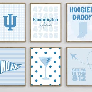 May include: Six framed prints with light blue and white designs. The prints feature a university logo, city name, state outline, and phrases like "Hoosier Daddy" and "See Ya in the 812".