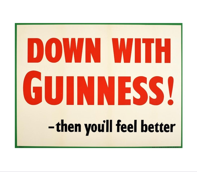 May include: A white sign with a green border reads "Down with Guinness! -then you'll feel better". The text "Down with Guinness!" is in red letters, and the rest of the text is in black.