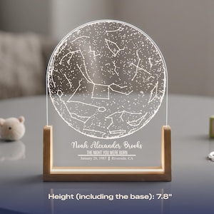 May include: A personalized night sky map, 7.8 inches tall, with a wooden base. The clear acrylic panel displays a constellation design and the text "Noah Alexander Brooks, The Night You Were Born, January 28, 1987, Riverside, CA."