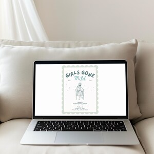 May include: A laptop displaying a light green and white graphic with the text "Girls Gone Mild." The graphic includes an illustration of a person sitting in a chair. The laptop is on a beige couch.
