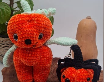 May include: An orange crochet pumpkin spider and a keychain spider are displayed on a wooden surface. The larger pumpkin spider has green accents and black eyes. The keychain spider has a black hat. Text at the top reads "Bundle Pumpkin Spider Jack the Pumking PDF".