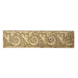 May include: A rectangular, decorative tile with a repeating scroll and leaf pattern. The tile has a textured, aged appearance with a light beige background and darker brown detailing. The design features a series of swirling scroll motifs.